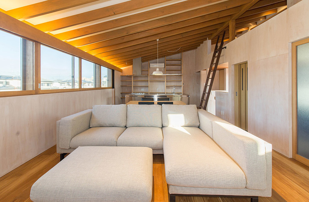 Living room - medium tone wood floor and brown floor living room idea in Other with beige walls