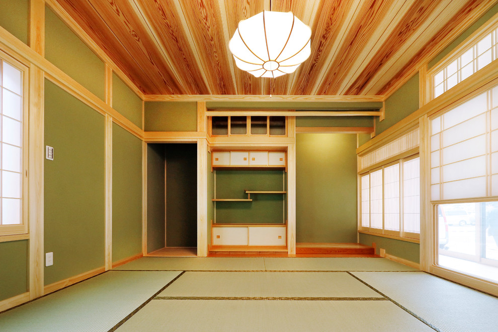 World-inspired living room in Other with green walls, tatami flooring and green floors.