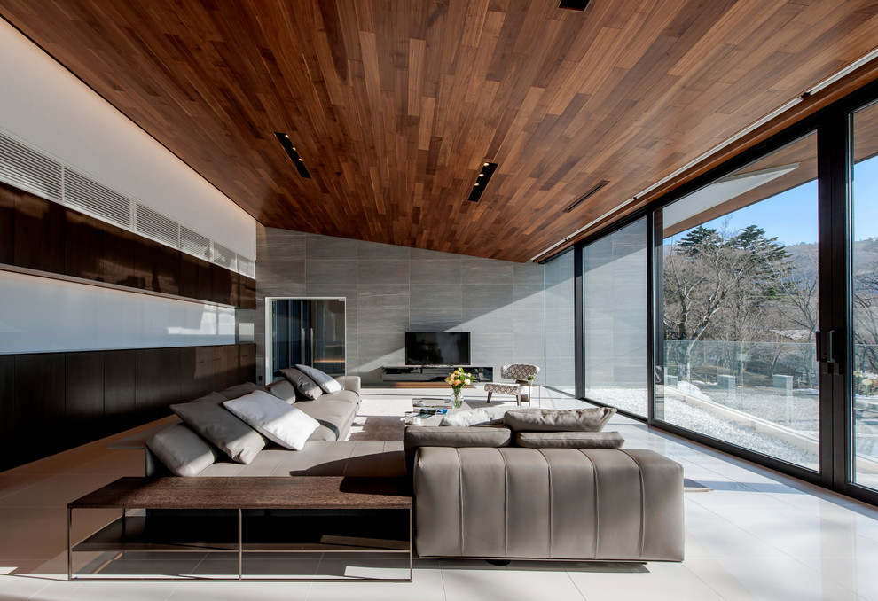 Trendy formal and open concept ceramic tile and white floor living room photo with a ribbon fireplace and gray walls