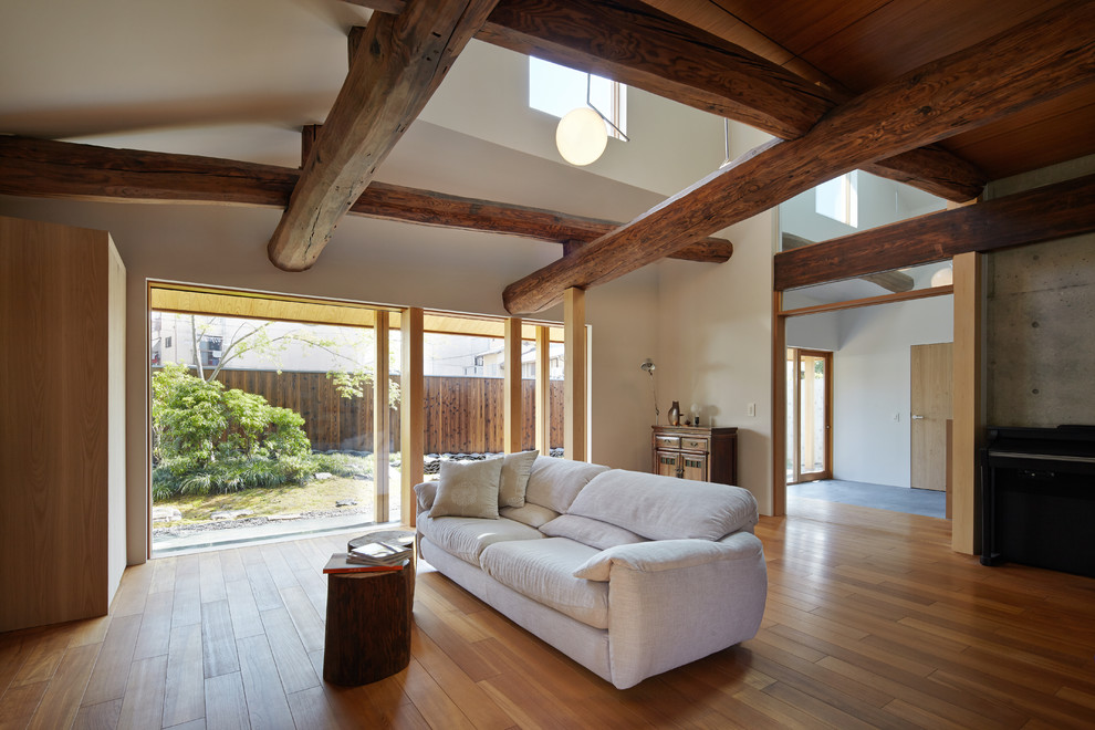 This is an example of a world-inspired living room in Kyoto with multi-coloured walls and medium hardwood flooring.