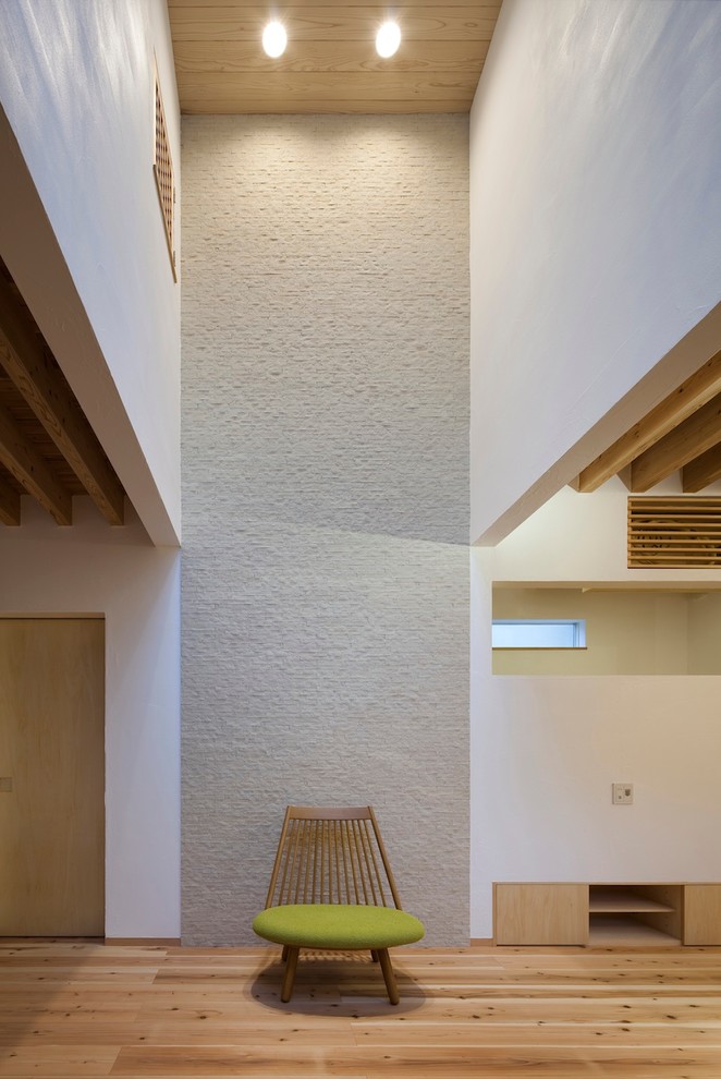 Immagine di un soggiorno minimalista con pareti bianche e pavimento in legno massello medio