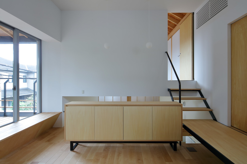 This is an example of a medium sized scandinavian enclosed living room in Osaka with white walls, plywood flooring, no fireplace and beige floors.