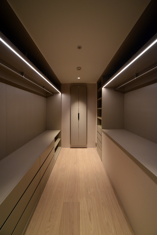 Idéer för att renovera ett litet orientaliskt walk-in-closet, med beige skåp