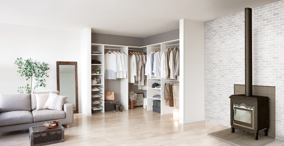 This is an example of a modern walk-in wardrobe in Other with open cabinets and white cabinets.