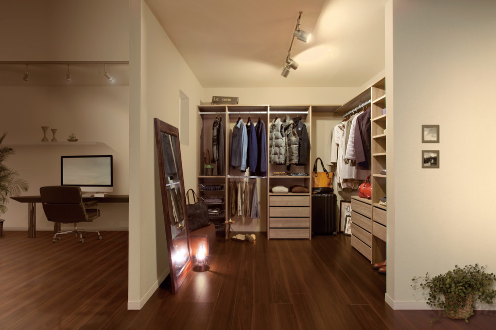 This is an example of a modern walk-in wardrobe in Other with open cabinets and light wood cabinets.