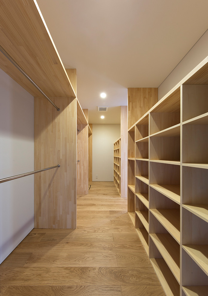 Idéer för ett litet modernt walk-in-closet för könsneutrala, med öppna hyllor, skåp i ljust trä, plywoodgolv och beiget golv
