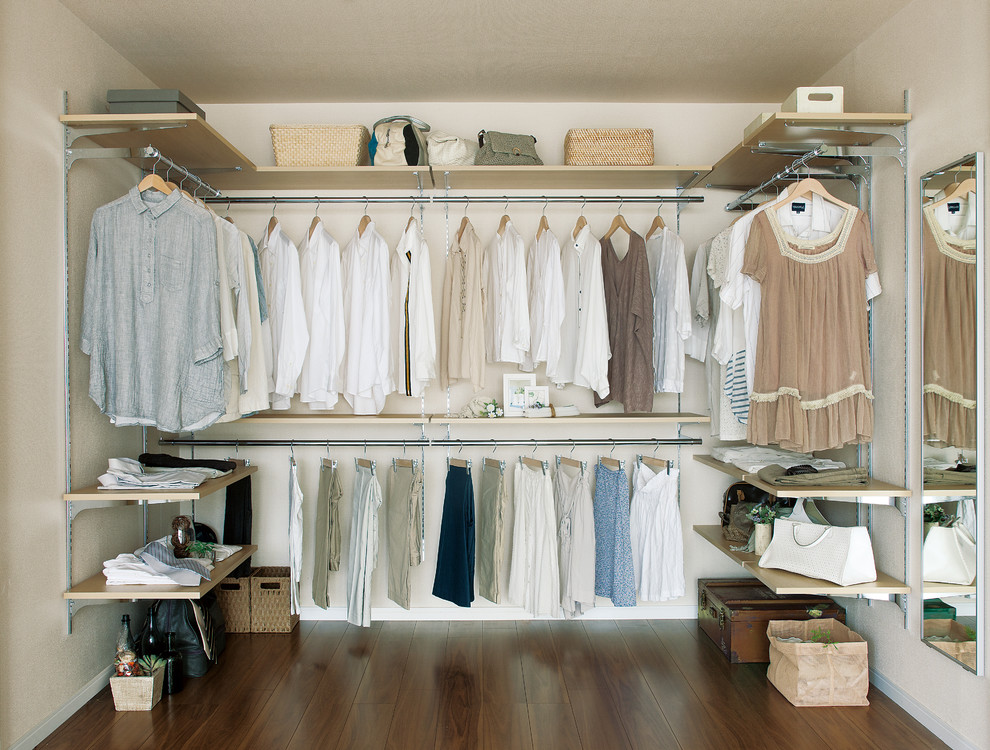 Example of a danish walk-in closet design in Other with open cabinets and light wood cabinets