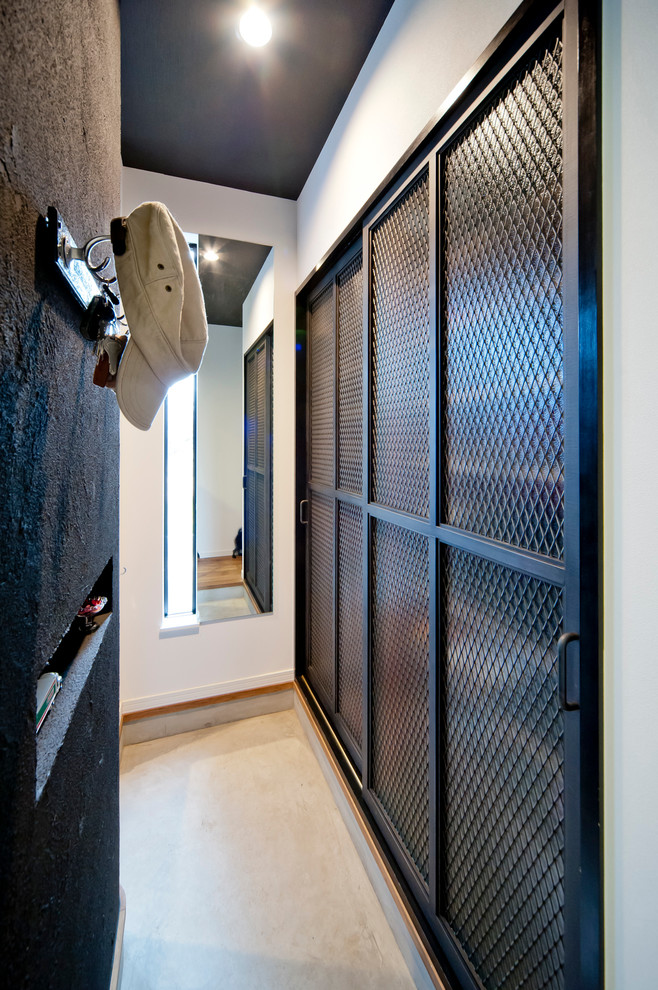 Example of an urban closet design in Nagoya with dark wood cabinets