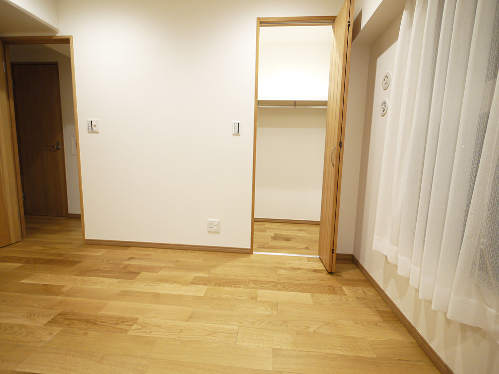 Walk-in closet - farmhouse medium tone wood floor walk-in closet idea in Tokyo