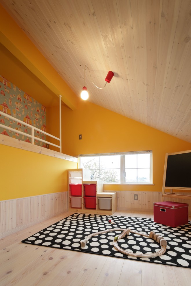 Bild på ett skandinaviskt barnrum, med gula väggar och ljust trägolv