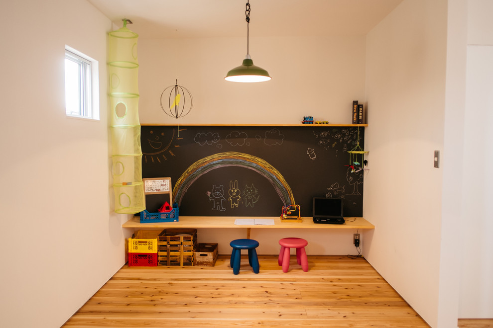 Inspiration för ett barnrum, med vita väggar och mellanmörkt trägolv