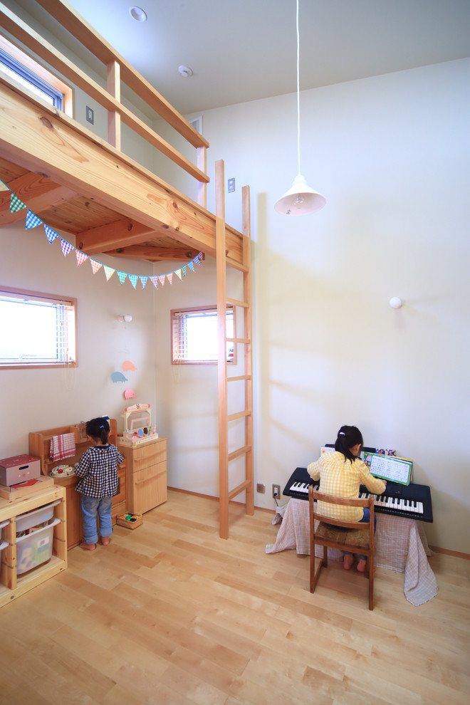 Esempio di una cameretta per bambini da 1 a 3 anni rustica con pareti beige, parquet chiaro e pavimento beige