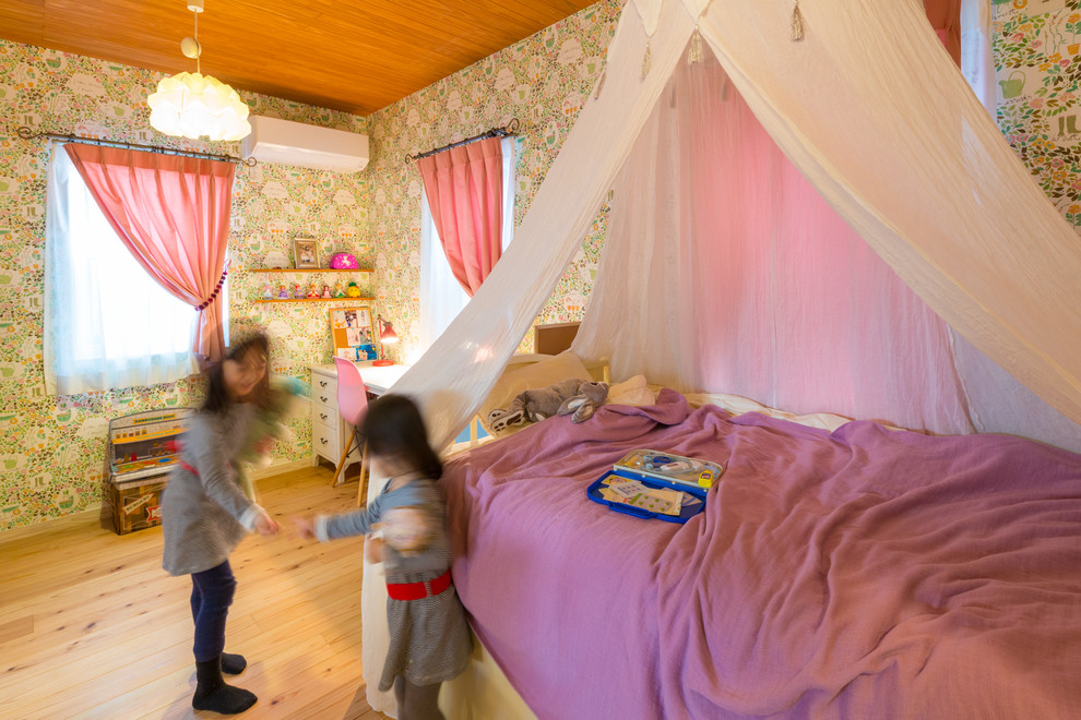 Inspiration for a medium sized scandi children’s room for girls in Other with multi-coloured walls, medium hardwood flooring and brown floors.