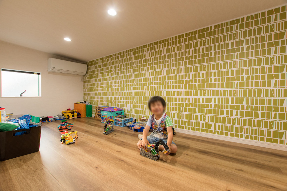 Immagine di una piccola cameretta per bambini da 1 a 3 anni nordica con pareti gialle, pavimento in legno massello medio, pavimento marrone, soffitto in carta da parati e carta da parati