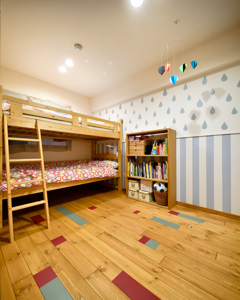 Inspiration for an asian medium tone wood floor and brown floor kids' room remodel in Other with multicolored walls