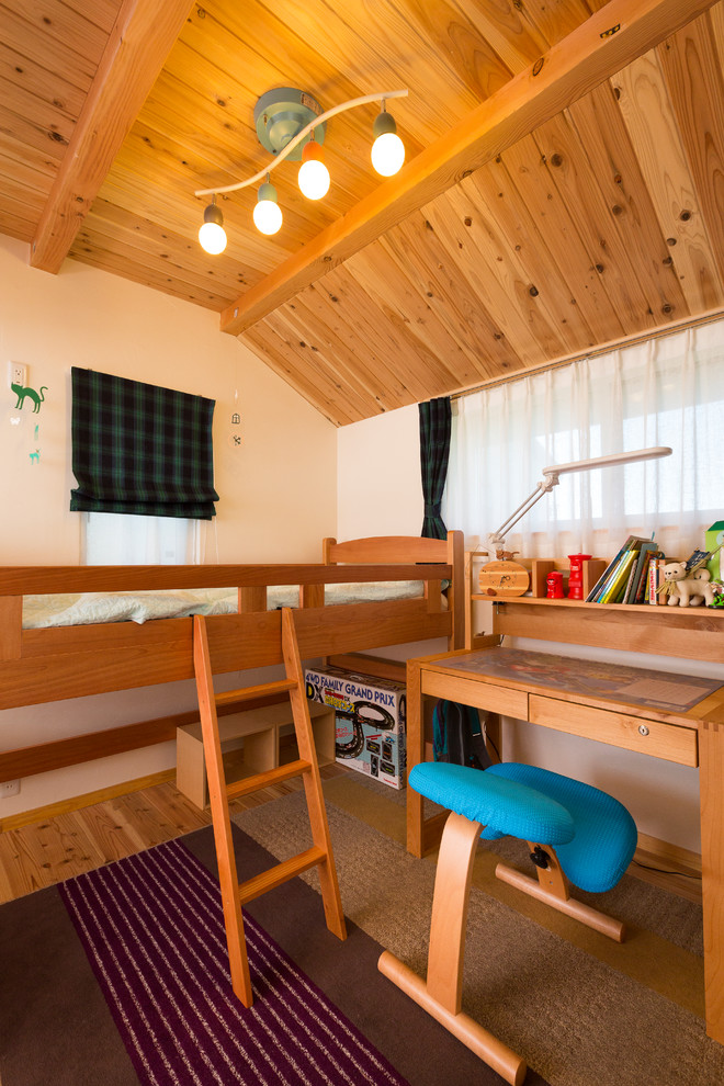 Example of a small mountain style boy medium tone wood floor and brown floor kids' room design in Nagoya with white walls