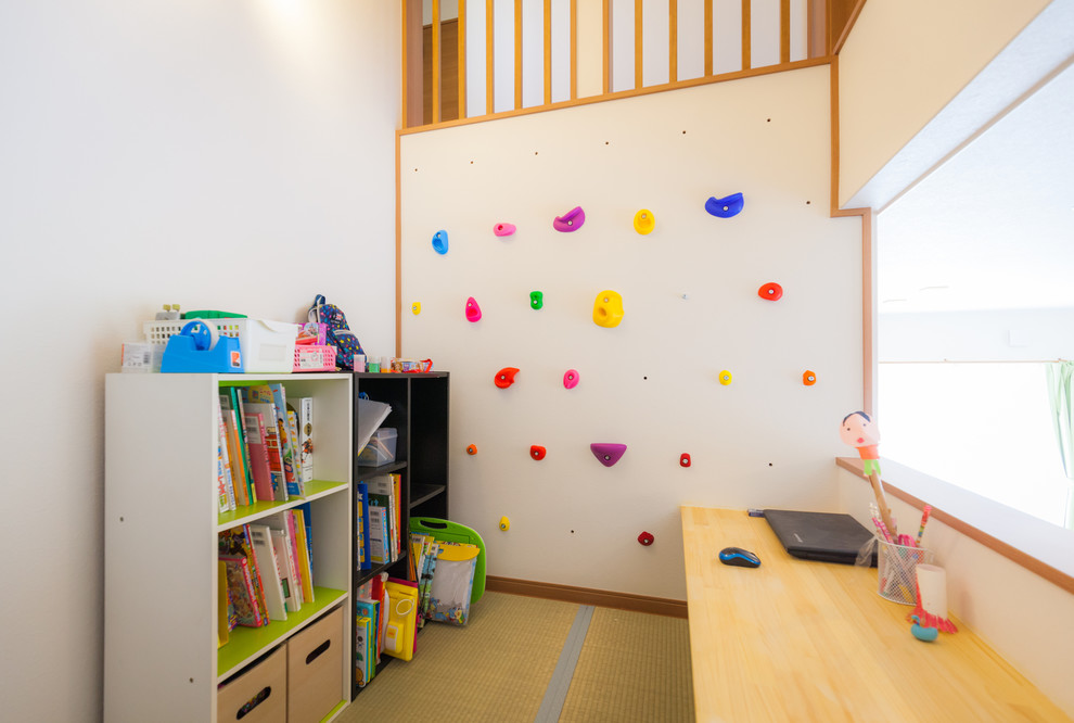 Contemporary gender neutral kids' bedroom in Other with beige walls.