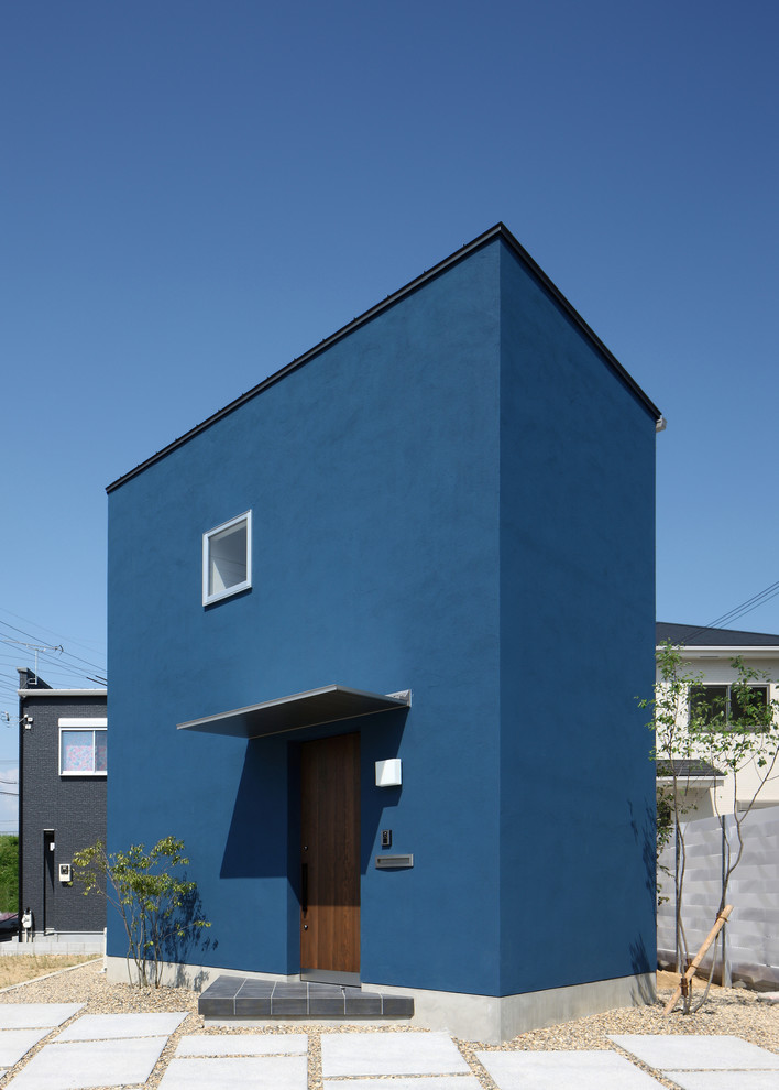 Example of a minimalist blue exterior home design in Other
