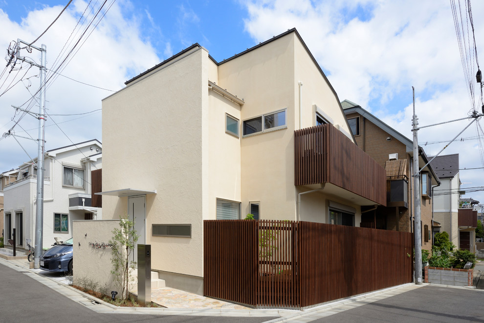 This is an example of a beige rustic two floor detached house in Tokyo.
