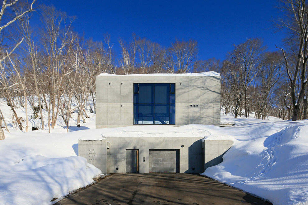 Inspiration for an industrial concrete house exterior remodel in Other
