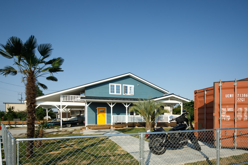 Diseño de fachada azul costera con revestimiento de madera y tejado a dos aguas