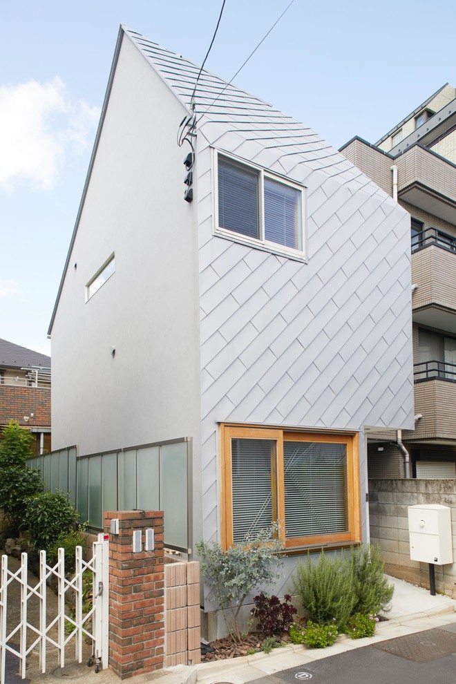 Inspiration for a small contemporary two floor detached house in Tokyo with a pitched roof and a metal roof.