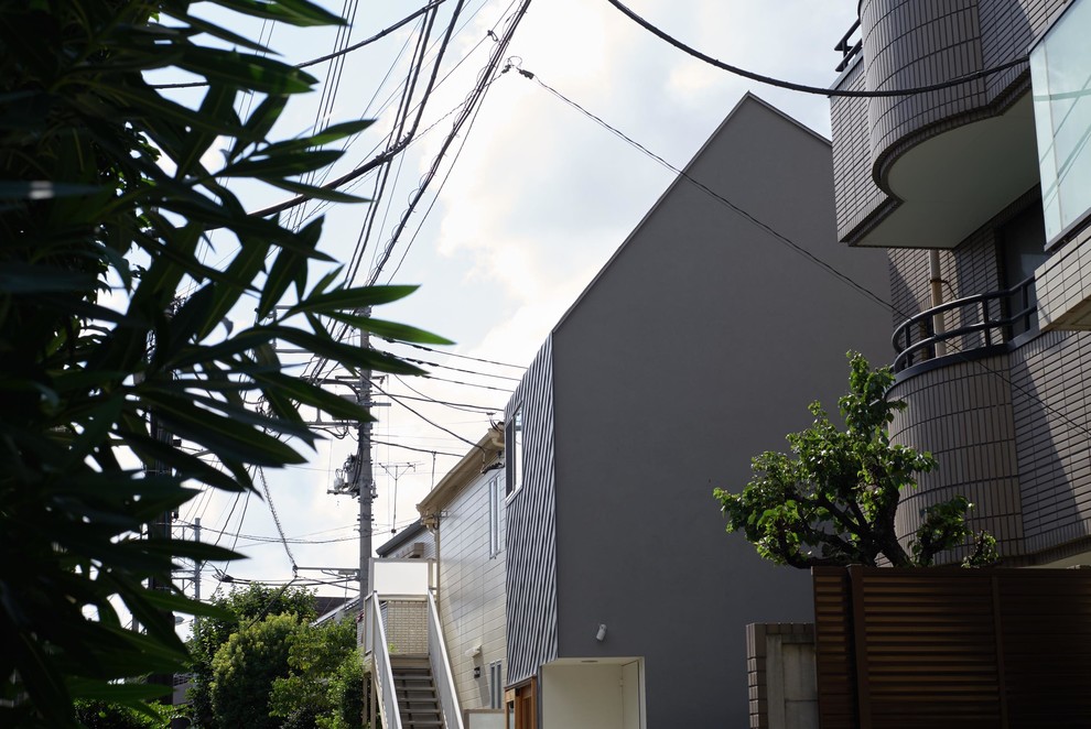 Foto de fachada de casa pequeña de dos plantas con tejado a dos aguas y tejado de metal