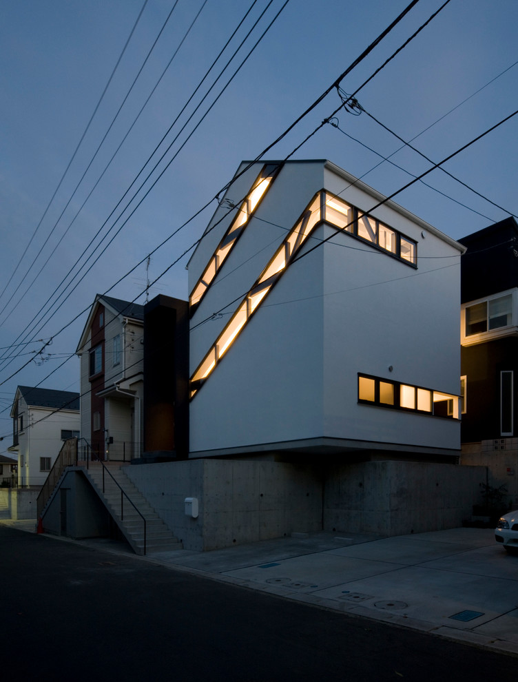 Inspiration for a white contemporary render detached house in Tokyo Suburbs with three floors and a pitched roof.