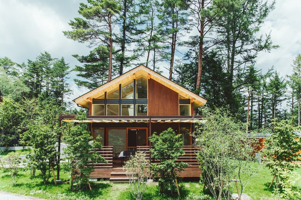Idée de décoration pour une petite façade de maison marron champêtre en bois avec un toit à deux pans.