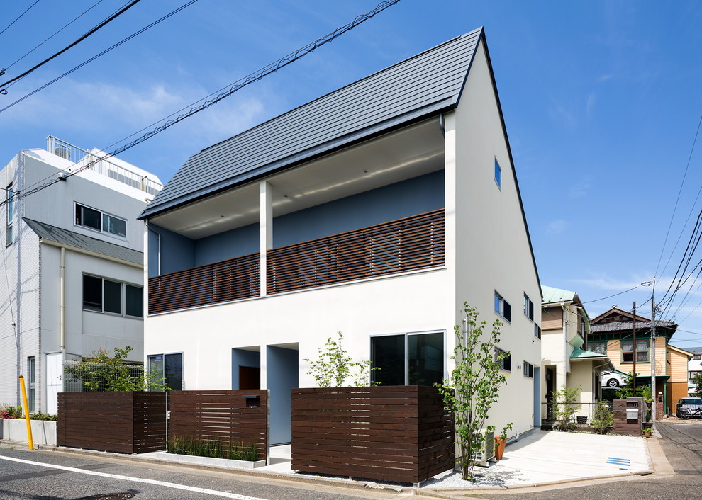 Foto de fachada blanca contemporánea con tejado a dos aguas