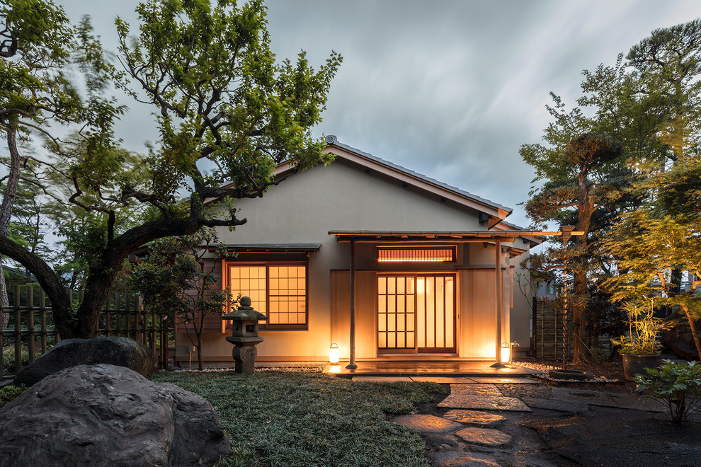 Mid-sized zen beige one-story exterior home photo in Other with a tile roof