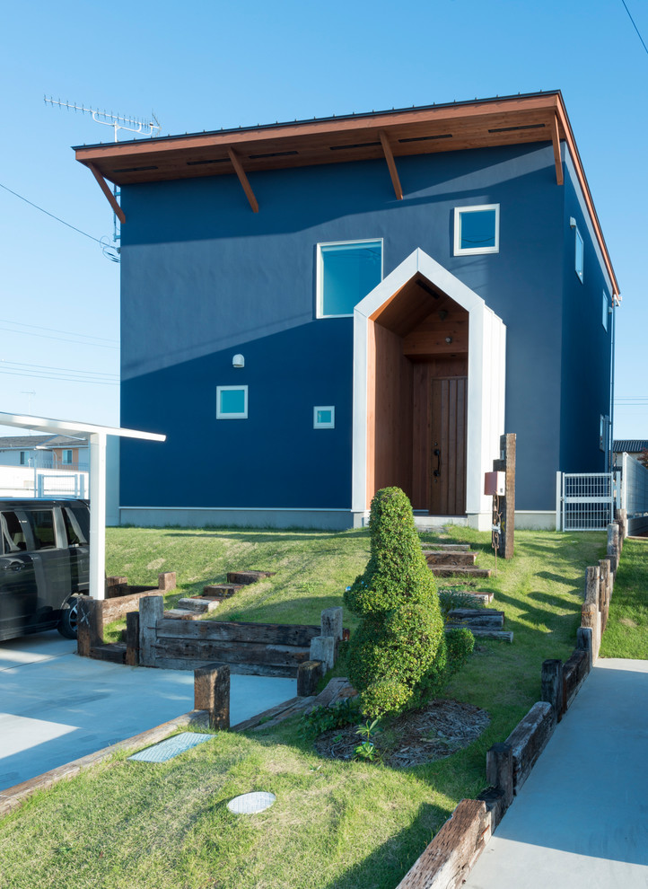 Modernes Haus mit blauer Fassadenfarbe und Flachdach in Sonstige