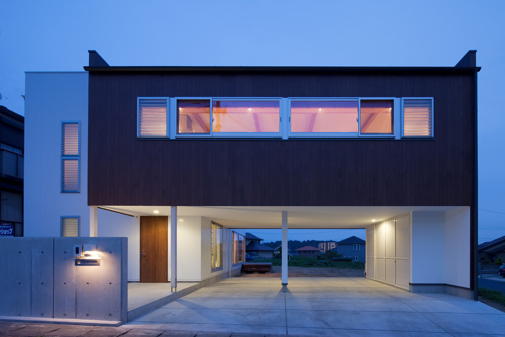 На фото: двухэтажный дом в стиле модернизм с комбинированной облицовкой и плоской крышей