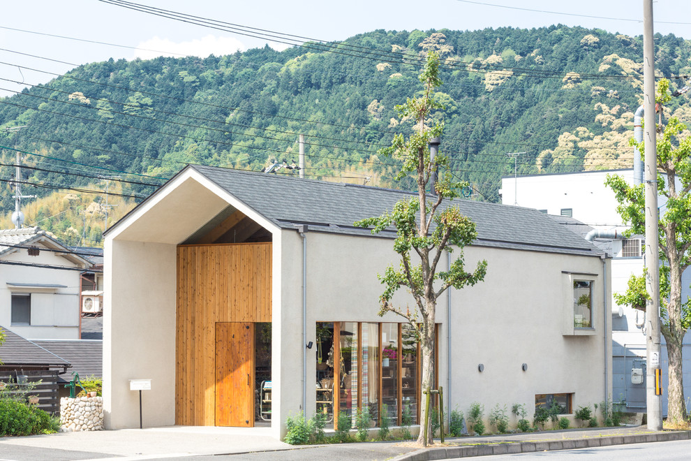 Design ideas for a white scandinavian house exterior in Kyoto with a pitched roof and a mixed material roof.