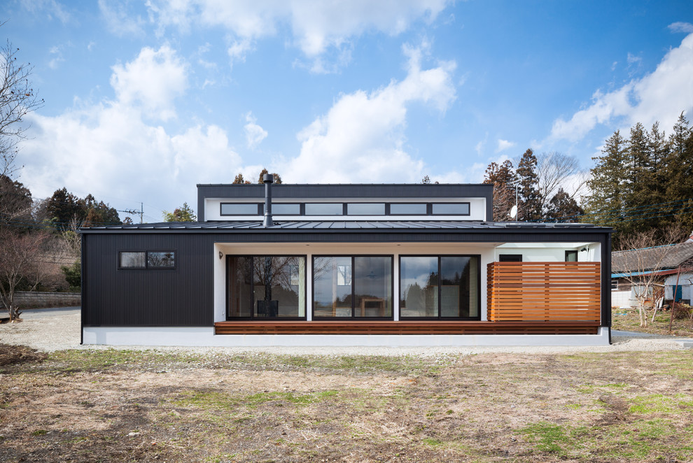 Black world-inspired house exterior in Other with a lean-to roof.