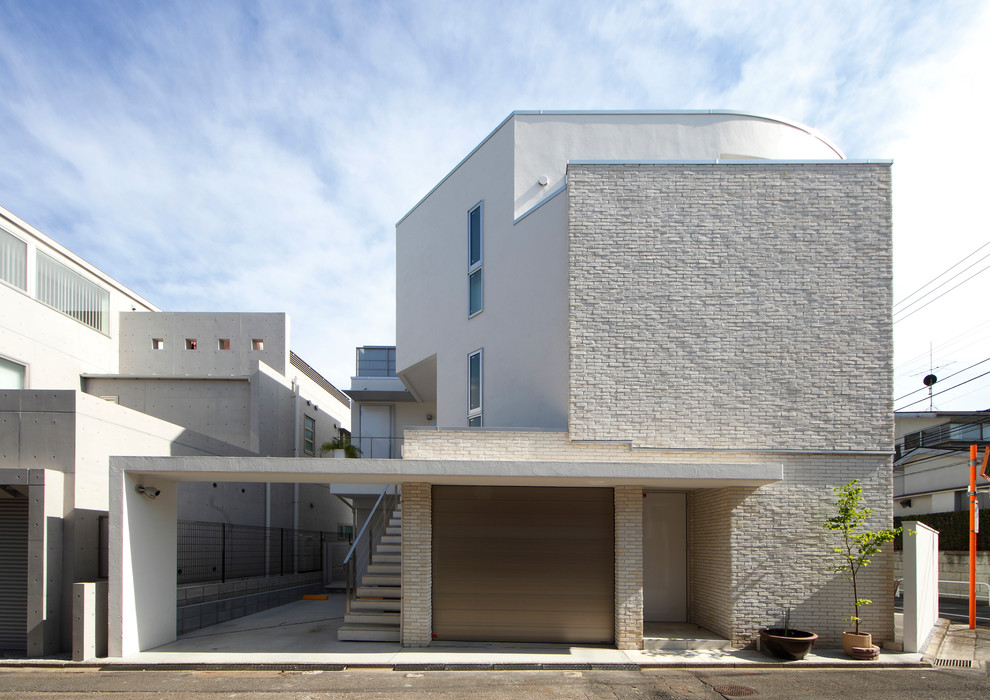 Réalisation d'une façade de maison minimaliste de taille moyenne et à deux étages et plus avec un toit en appentis et un toit en métal.