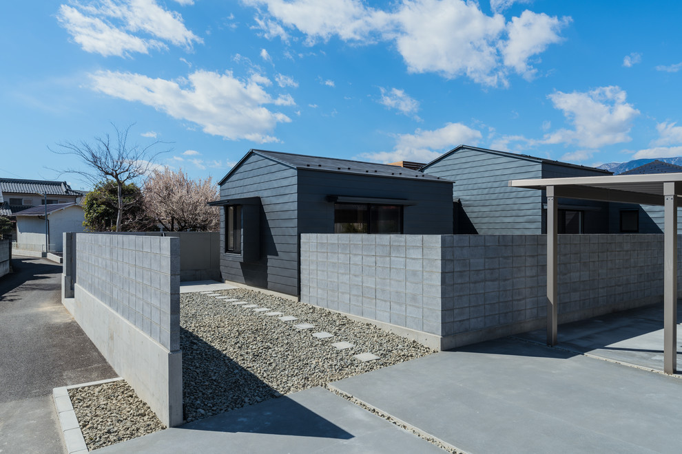 Diseño de fachada de casa gris actual extra grande de una planta con revestimiento de metal, tejado a dos aguas y tejado de metal