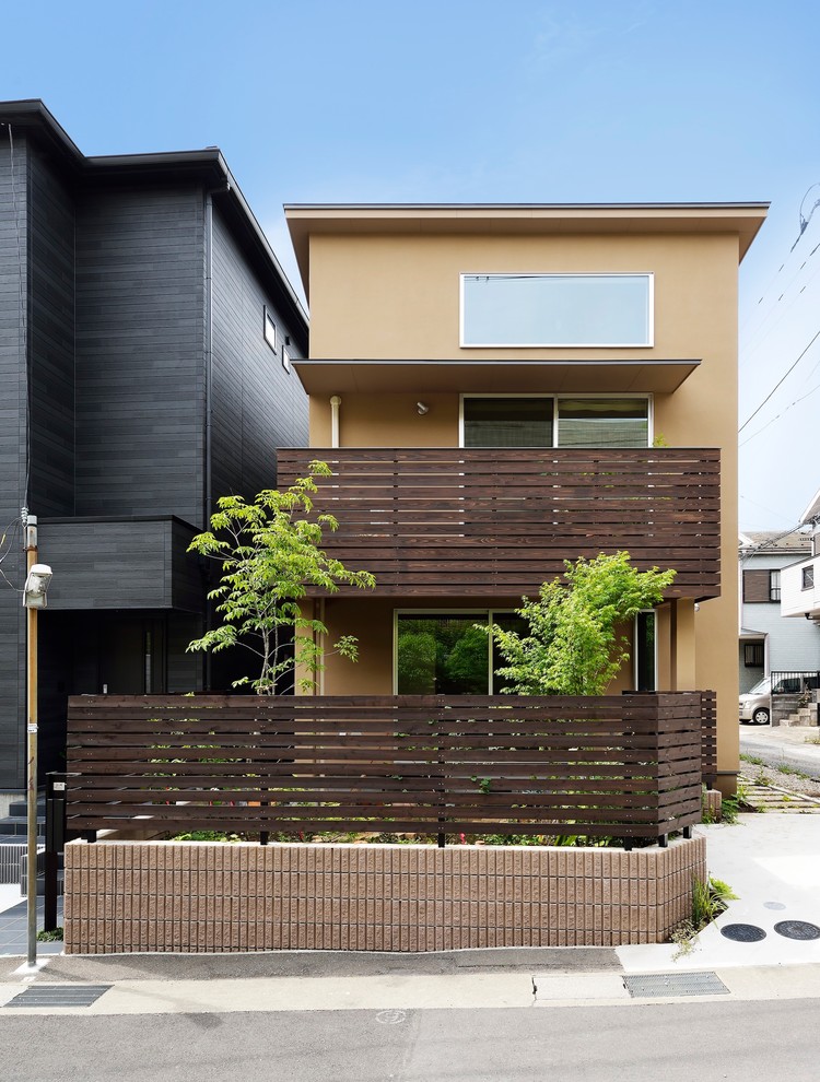 Inspiration för små moderna bruna hus, med två våningar, pulpettak och tak i metall