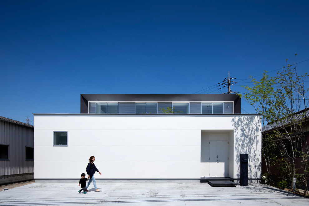 Photo of a medium sized and white modern two floor detached house in Other with mixed cladding, a pitched roof and a metal roof.