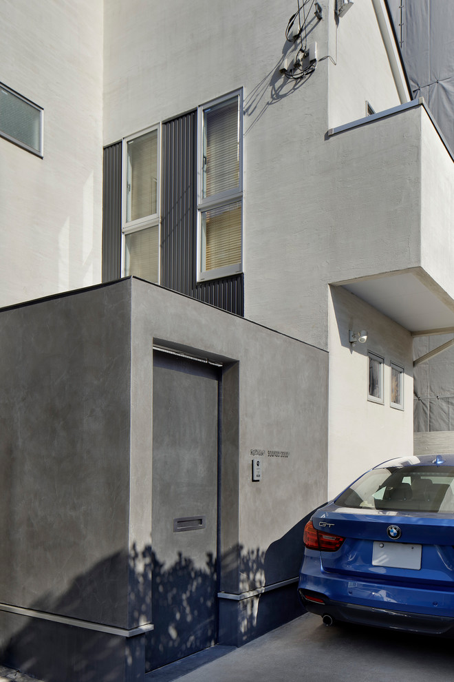 Small modern gray two-story house exterior idea in Tokyo