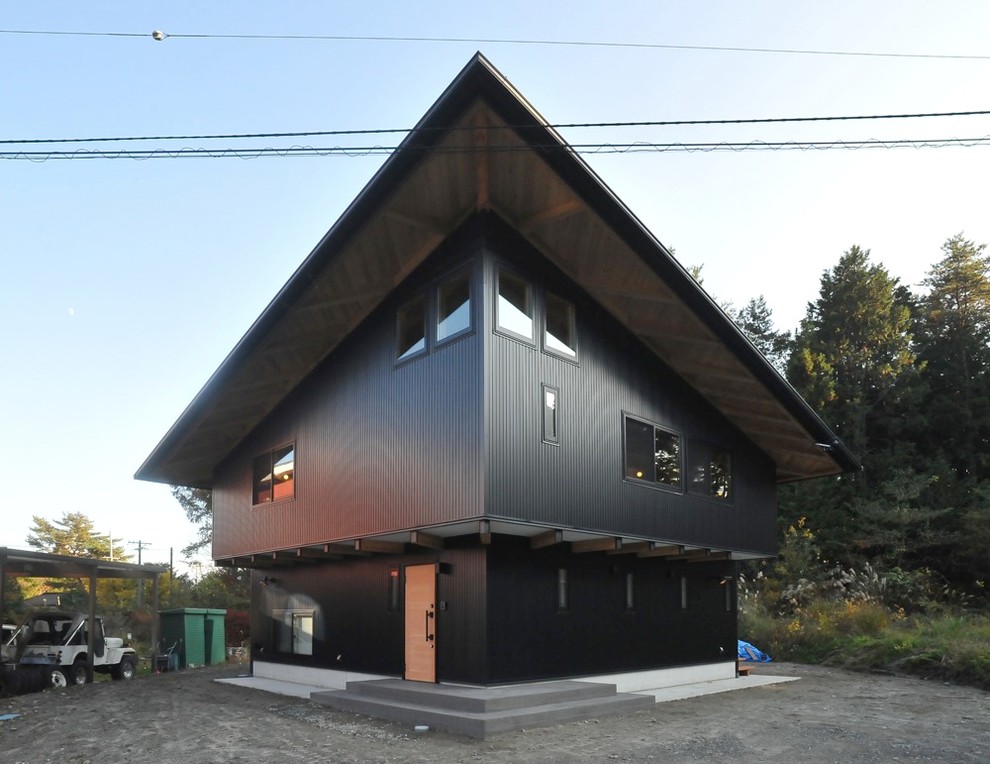 Modern black exterior home idea in Tokyo with a shed roof