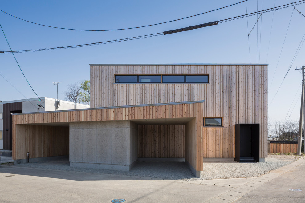 Idées déco pour une façade de maison marron contemporaine en bois avec un toit plat.