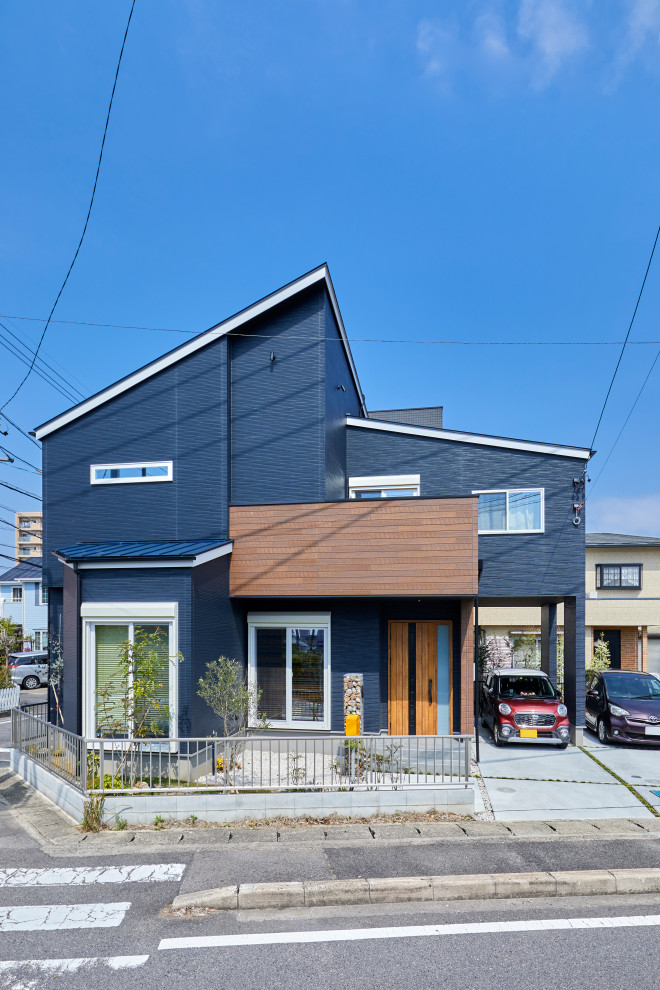 Mittelgroßes, Zweistöckiges Haus mit gestrichenen Ziegeln, blauer Fassadenfarbe und Halbwalmdach in Nagoya