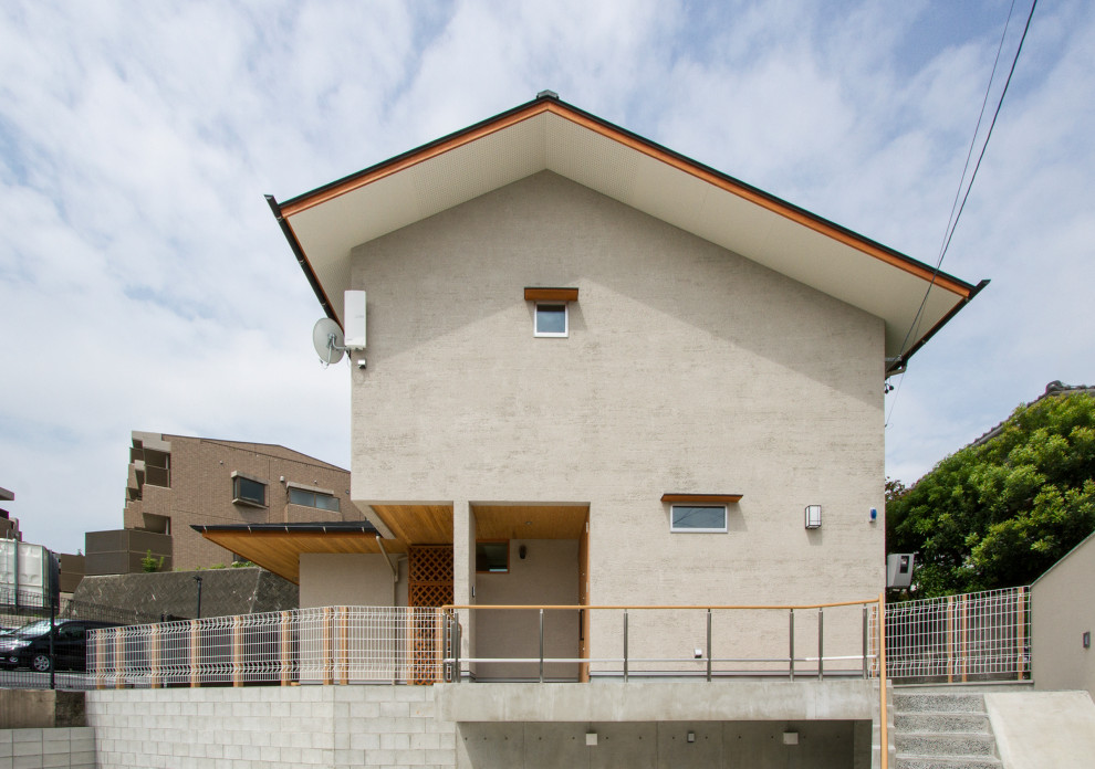 Mittelgroßes, Zweistöckiges Modernes Einfamilienhaus mit grauer Fassadenfarbe, Satteldach und Blechdach in Nagoya