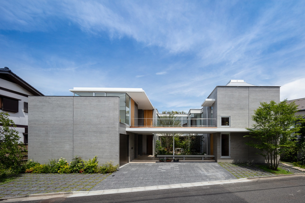 Idéer för ett modernt grått flerfamiljshus, med platt tak