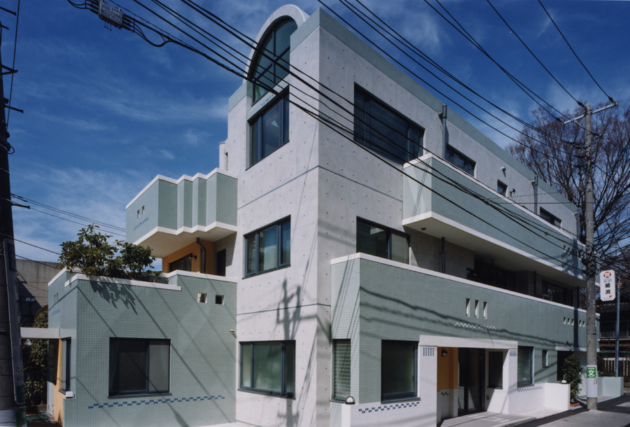 Example of a large minimalist gray three-story house exterior design in Other