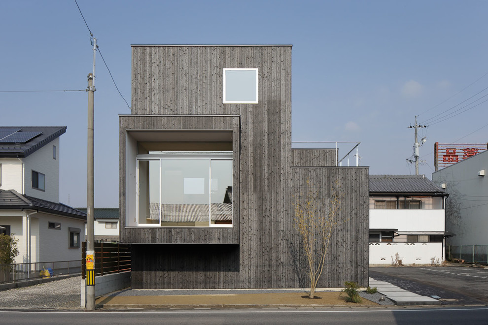 Inspiration for a gey contemporary house exterior in Other with wood cladding and a flat roof.