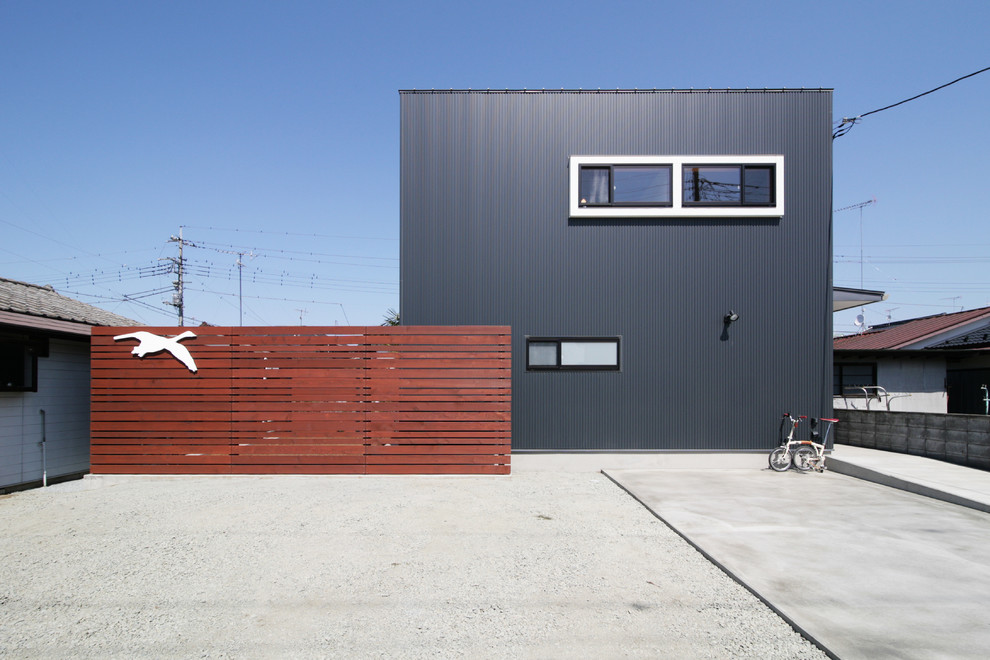 Black modern house exterior in Other with a flat roof.