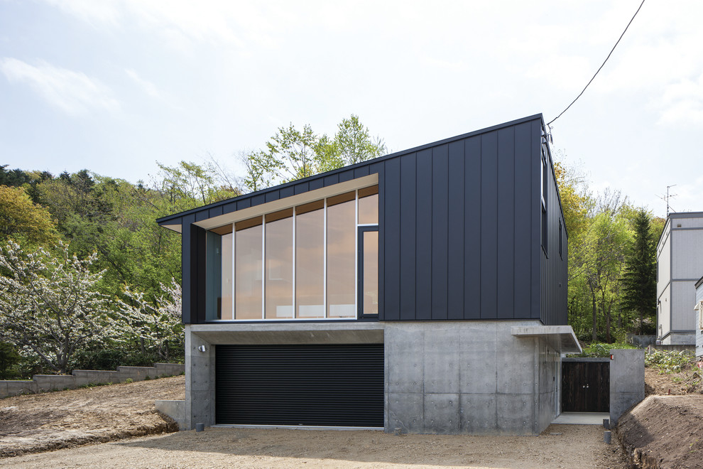 Trendy black exterior home photo in Sapporo with a shed roof