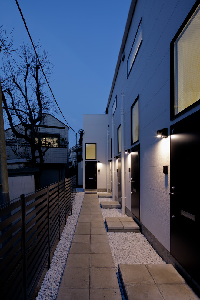 Inspiration för ett funkis vitt lägenhet, med tre eller fler plan, blandad fasad, pulpettak och tak i metall